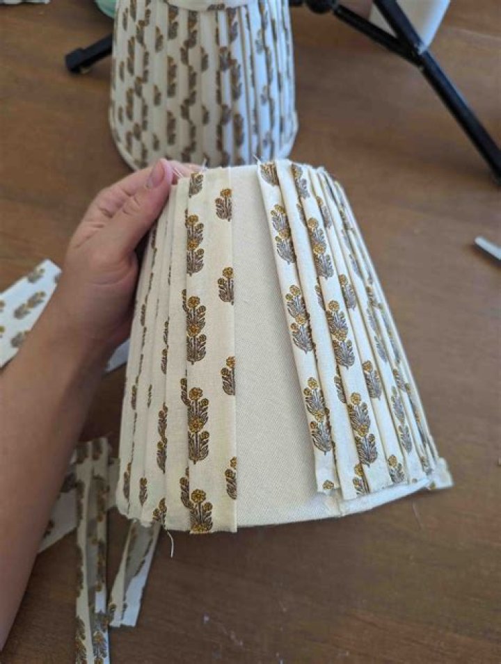 How do you cover a lampshade with fabric strips?