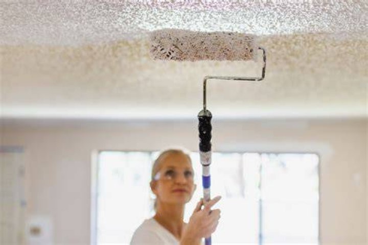 How do you prevent roller marks when painting a ceiling?